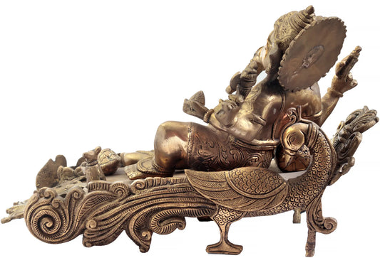 Brassaura® Reclining Lord Ganesha on Peacock Couch | Handcrafted Brass Sculpture | Height 10 Inches & Weight 8.80 kgs