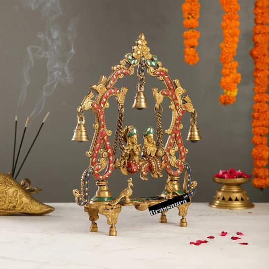 Brassaura™ Brass Radha Krishna on Swing with Diyas, Peacocks & Bells – Height 13.5 Inches & Weight 2.4 Kgs | Elegant Devotional Idol