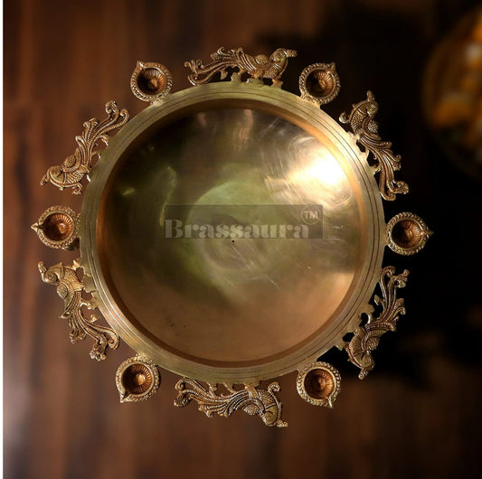 Brassaura™ Magnificent Peacock Brass Urli – 16 kgs, 7.5 Inches Height – Decorative Urli with 6 Diyas & Bells for Home Decor