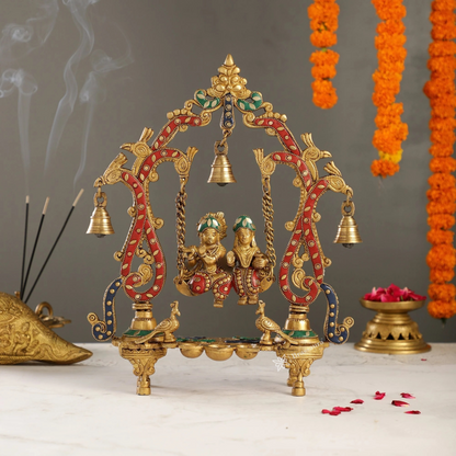 Brassaura™ Brass Radha Krishna on Swing with Diyas, Peacocks & Bells – Height 13.5 Inches & Weight 2.4 Kgs | Elegant Devotional Idol