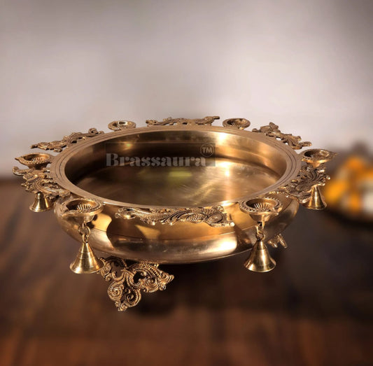 Brassaura® Magnificent Peacock Brass Urli – 16 kgs, 7.5 Inches Height – Decorative Urli with 6 Diyas & Bells for Home Decor