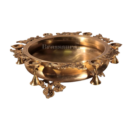 Brassaura™ Magnificent Peacock Brass Urli – 16 kgs, 7.5 Inches Height – Decorative Urli with 6 Diyas & Bells for Home Decor